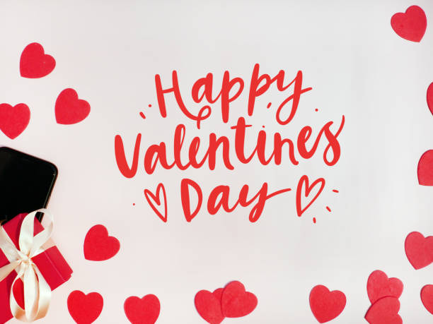 Valentine's day card. Composition with gifts, red hearts, mpbile phone and sign Happy Valentines Day on white surface Valentine's day card. Composition with gifts, red hearts, mpbile phone and sign Happy Valentines Day on white surface. contributor stock pictures, royalty-free photos & images