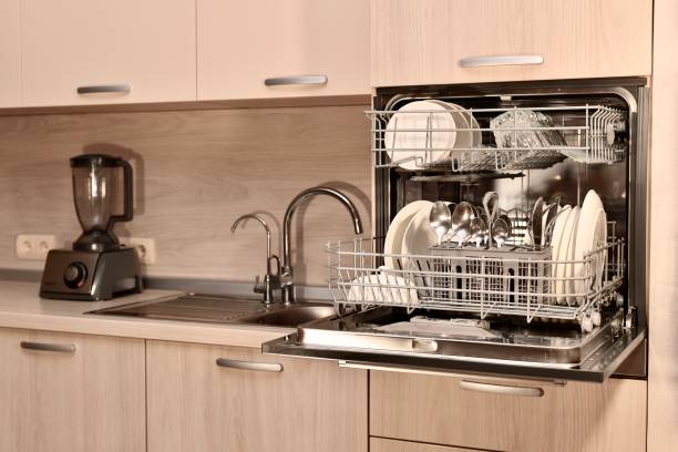 istock Fragment of the kitchen headset with an open dishwasher, conveniently installed at the level of the mistress's belt. 1203138484