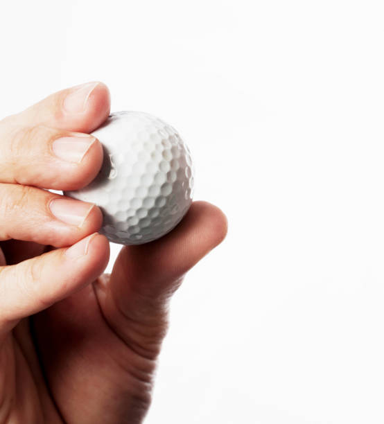 istock Hand holding golf ball against white background 1203141245