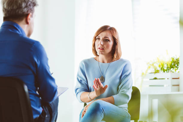 istock Worried woman talking with psychotherapist 1203143099
