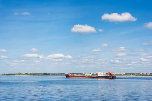 Cargo ship goes down the river in spring
