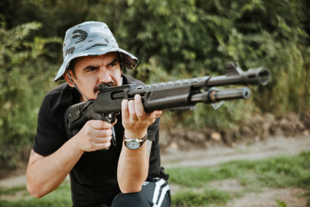 istock Male hunter aiming his rifle and preparing to shoot 1203143469