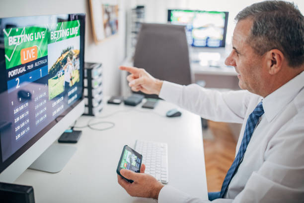 istock One business man using computer and smart phone for live betting 1203144401