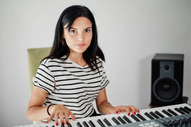 istock Young girl playing the piano 1203144480