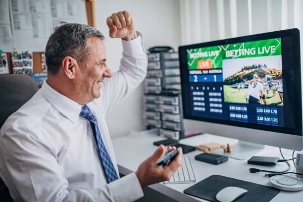 istock One senior man using computer and smart phone for live betting in office 1203144584