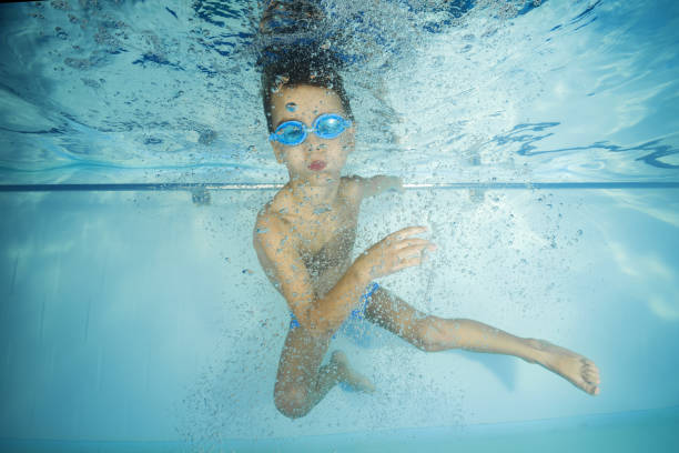 istock A boy in goggles plays underwater in a swimming pool 1203145629