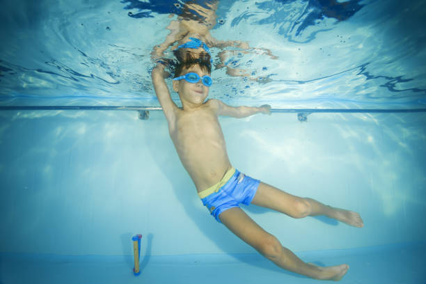 istock A boy in goggles plays underwater in a swimming pool 1203145693
