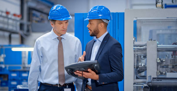 istock Engineer and supervisor discussing in factory 1203146813