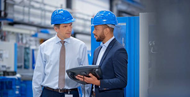 istock Engineer and supervisor discussing in factory 1203146814