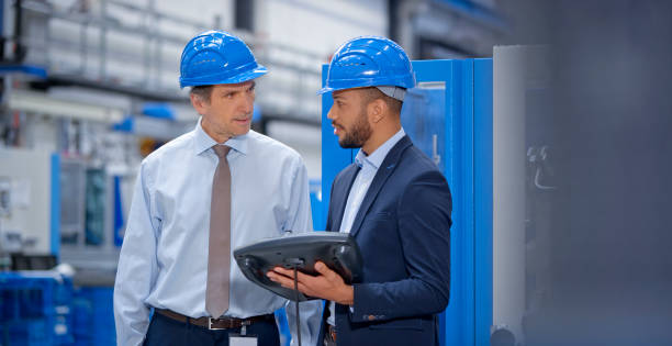 istock Engineer and supervisor discussing in factory 1203146815