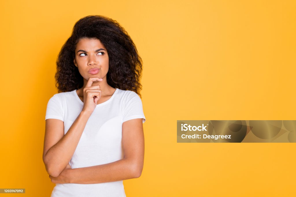 Photo of pensive concentrated focused girl looking thoughtfully into empty space touching her chin isolated vivid color background Photo of pensive concentrated focused girl looking thoughtfully into empty space, touching her chin isolated vivid color background One Woman Only Stock Photo