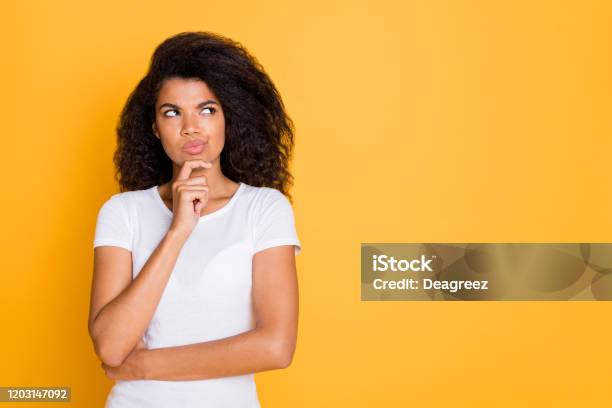 Photo Of Pensive Concentrated Focused Girl Looking Thoughtfully Into Empty Space Touching Her Chin Isolated Vivid Color Background Stock Photo - Download Image Now