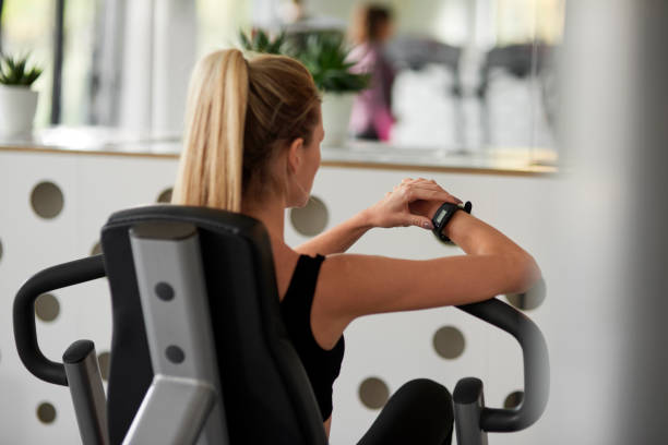 istock Rear view of female athlete using technology at the gym 1203148350