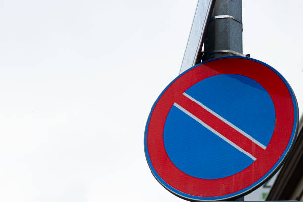 istock No parking road sign against background. Hanging on the pole . 1203148478