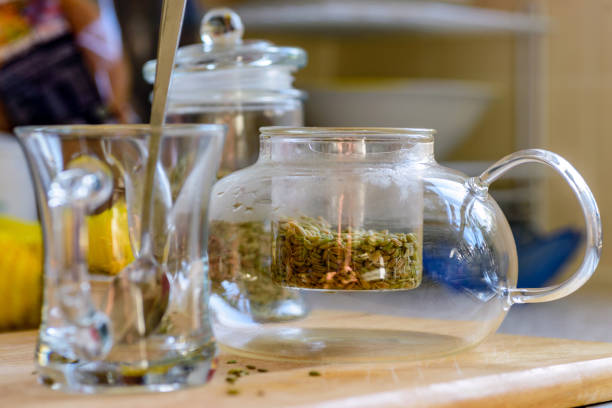 fennel seeds inside glass teapot being brewed for healthy drink.