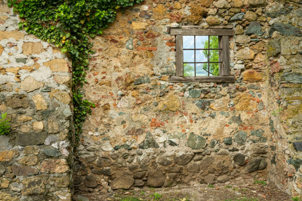 istock Small window of an old desolated house 1203155744