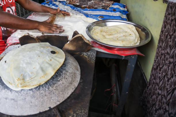 istock Man Preparing and cooking chapati roti 1203158335