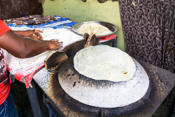 istock Man Preparing and cooking chapati roti 1203158354