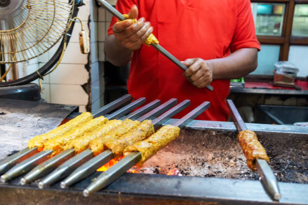 Unidentified Man grilling an Indian Chicken and Mutton Kebabs Unidentified Man grilling an Indian Chicken and Mutton Kebabs at Chandni Chowk in Old Delhi India old delhi stock pictures, royalty-free photos & images