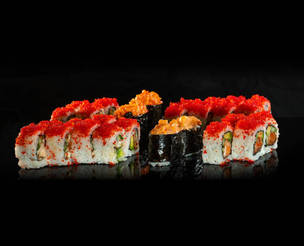 istock Japanese Sushi isolated on black background. Reflection in a mirror surface. Close up. Studio photo. 1203158466
