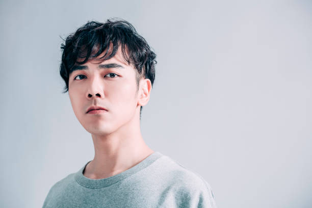 istock young  asian handsome man isolated on gray background 1203159586