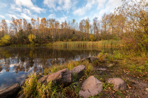 istock Autumn foilage on rocky lakeshore 1203159773