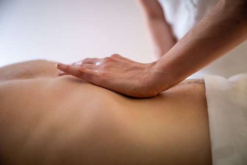 Hands massaging male abdomen.Therapist applying pressure on belly