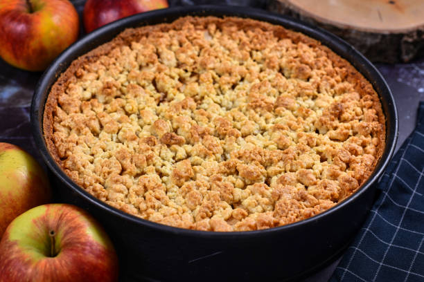 istock Whole traditional European apple pie with topping crumbles in springform pan 1203163155