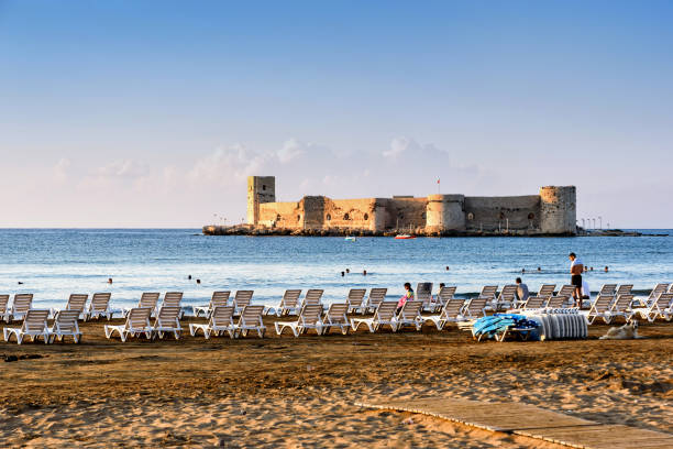 Maiden's castle, Kiz Kalesi with deckchairs in Mediterranean Sea. Mersin Turkey Mersin, Turkey - August 16, 2019: Maiden's castle, Kiz Kalesi with deckchairs in Mediterranean Sea. Mersin Turkey in summer maiden stock pictures, royalty-free photos & images