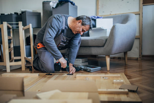 istock One senior carpenter assembling wooden furniture 1203165296