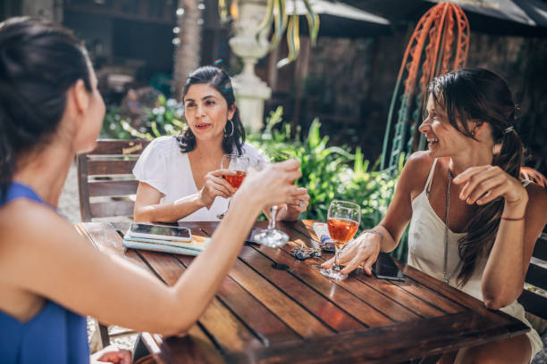 istock Beautiful women sitting outdoors in cafe 1203166268