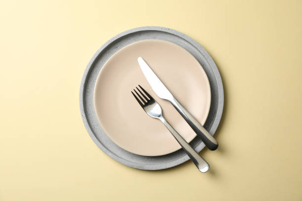 istock Tray with plate, fork and knife on beige background, top view 1203166765