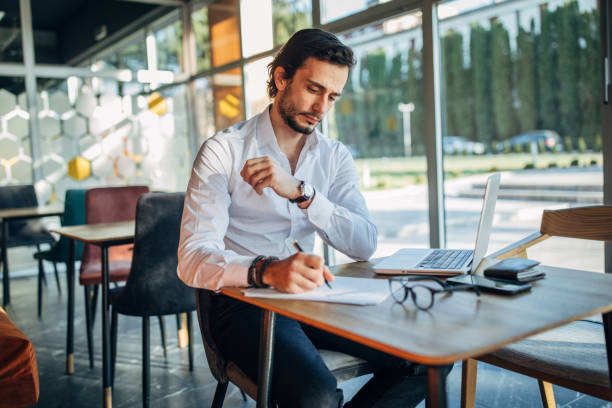 istock Young businessman working in cafe alone 1203168394