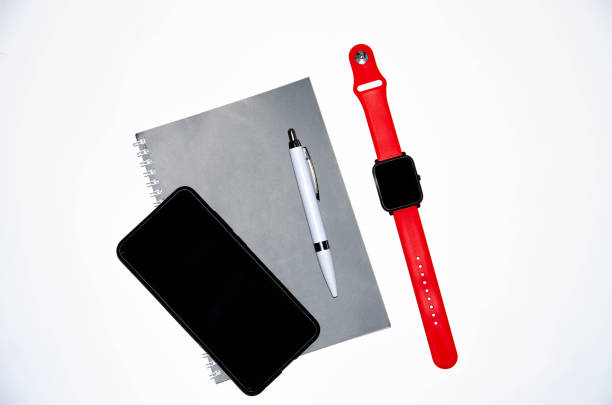 istock Gray notebook for writing on black background. Ballpoint pen. Smart watch with a red strap. Flat Lai, copies of the paste. View from different sides. Smartphone. Businessmen set kit white background. 1203169172