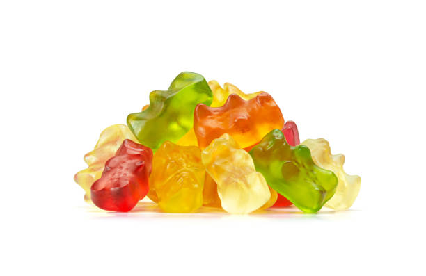 Macro of Assorted Fruit Flavored Gummy Bears or Cannabis Edibles Isolated on White Background A macro or close up image of a small pile of fruit flavored cannabis edibles or gummy bears, a gelatin based candy, isolated on a white background. gummy candy photos stock pictures, royalty-free photos & images