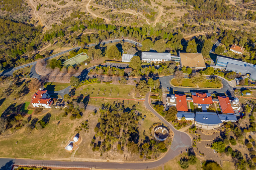 Aerial view of Mount Stromlo Observatory located in Canberra, the Australian Capital Territory showing large telescopes, some of the observatory\