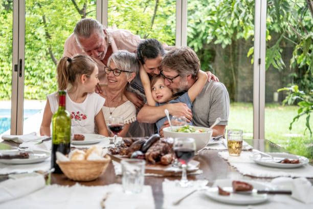 istock Extended family embracing while taking a family photo 1203171706