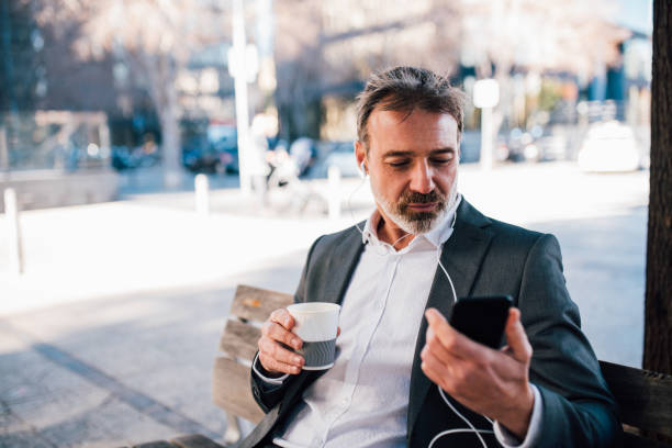 istock Businessman podcasting and enjoying coffee 1203171758