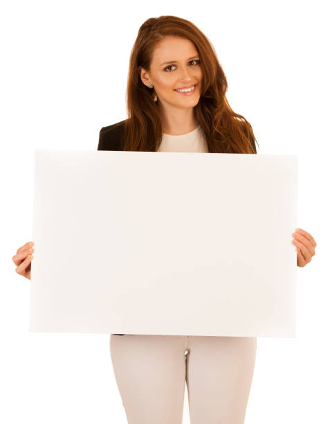 istock attractive business woman holding white banner with copy spave for additional text or graphic isolated over white 1203172111