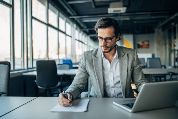 istock Modern businessman working in office 1203172384