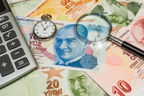 istock close up turkish lira banknotes with clock, magnifier and calculator 1203172421