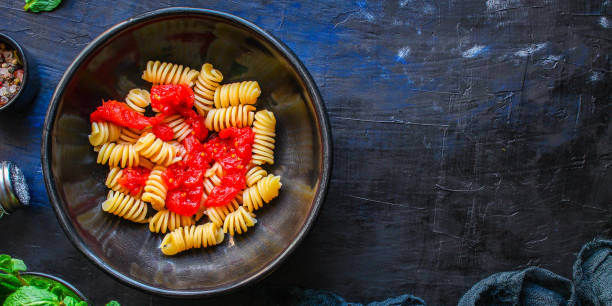 istock pasta rotini tomato sauce (vegetarian dish, Italian cuisine) menu concept. background. top view. copy space 1203173399