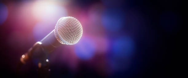 Microphone on stage at concert or event background Microphone on stage at concert or music performance background rock n roll music speakers stock pictures, royalty-free photos & images