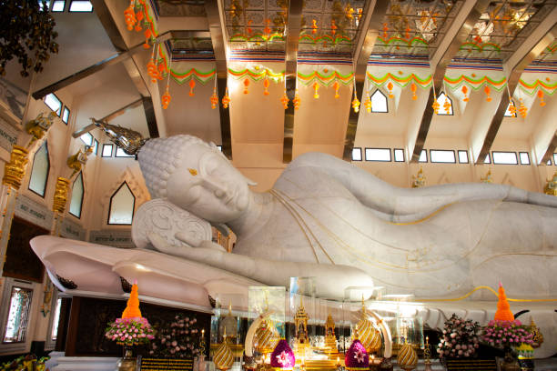 Wat pa phu kon temple in Udon Thani, Thailand UDONTHANI, THAILAND - DECEMBER 18 : Large reclining Buddha marble statue for people and travelers travel visit and respect praying at Wat pa phu kon temple on December 18, 2019 in Udon Thani, Thailand udon thani stock pictures, royalty-free photos & images
