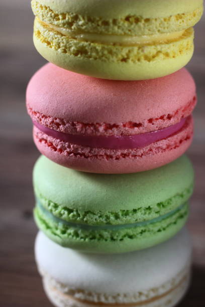 istock colored French cakes on a textured wooden background 1203174752