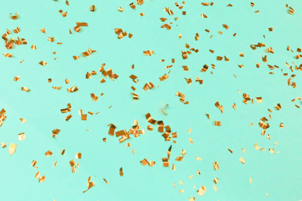 istock Golden flying sparkles on blue holiday background. Festive backdrop for your projects. 1203176045