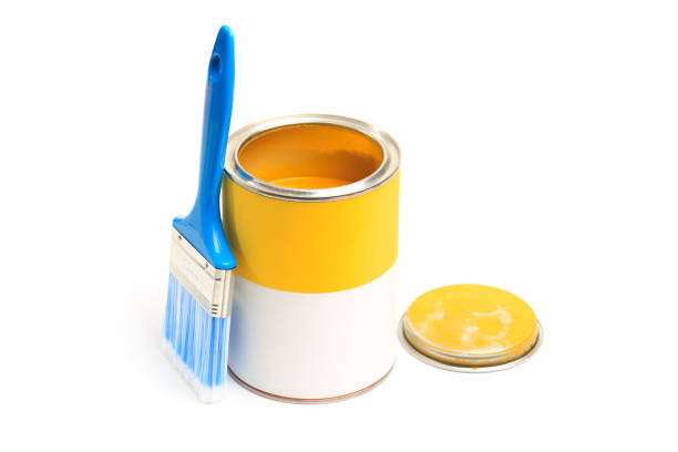 Can with yellow paint with brush isolated on white background - Image
