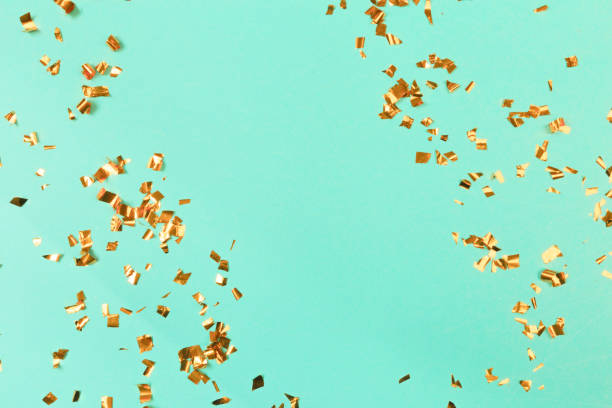 istock Golden flying sparkles on blue holiday background. Festive backdrop for your projects. 1203176142
