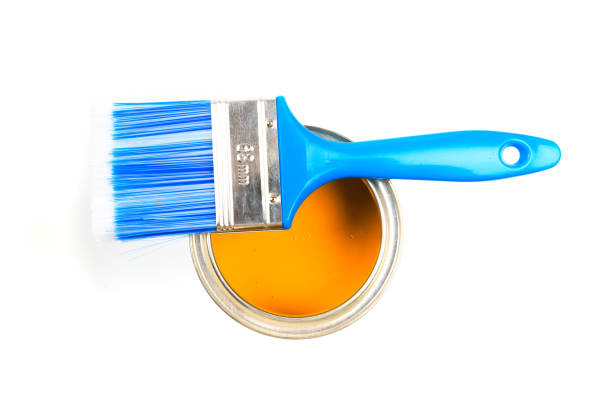 istock Can with yellow paint and brush isolated on white background top view - Image 1203176331