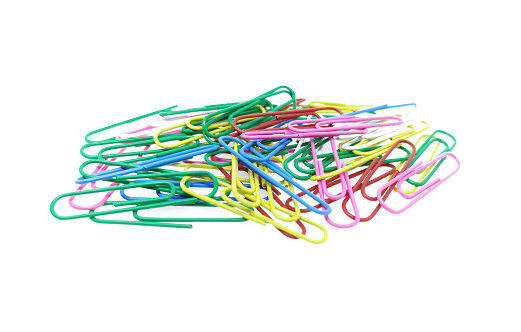 pile of office paper clips over white background